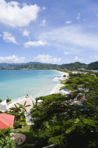 Waves of the aquamarine sea breaking on the two mile stretch of the white sandy Grand Anse Beach with the capital city of St Georges in the distanceCaribbean Grenadian Greneda West Indies Grenada 2 B...