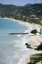 Waves of the aquamarine sea breaking on the two mile stretch of the white sand Grand Anse BeachCaribbean Grenadian Greneda West Indies Grenada 2 Beaches Holidaymakers Resort Sandy Scenic Seaside Shor...