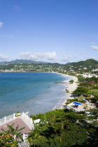 Waves of the aquamarine sea breaking on the two mile stretch of Grand Anse Beach with people on the white sandy beachCaribbean Grenadian Greneda West Indies Grenada 2 Beaches Holidaymakers Resort Sce...