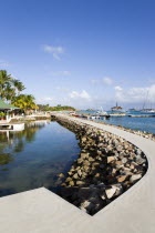 The concrete path around the shark pool at the Anchorage Yacht Club with boats moored in Clifton Harbour beyondCaribbean Ecology Entorno Environmental Environnement Green Issues Scenic West Indies Wi...