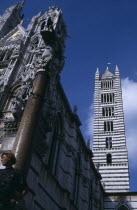 The front and side of the cathedral with the column of Romulus and Remus in the foregroundItalia Italian Religion Southern Europe European History One individual Solo Lone Solitary Religious Toscana...