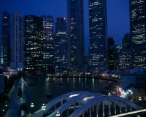 Singapore River basin and city skyline at night with lights from waterfront buildings reflected in water.Asian Nite Singaporean Singapura Southeast Asia Southern Xinjiapo