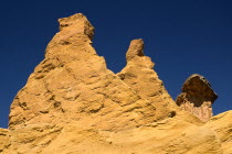 Colorado Provencal.  Cheminee de Fee or Fairy Chimneys.  Looking up at eroded  capped rock pinnacles on summit of ochre cliff from below.Ochre Trail European French Western Europe