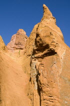 Colorado Provencal.  Cheminee de Fee or Fairy Chimneys.  View of eroded  ochre rock forms against cloudless blue sky from the park trail.Ochre Trail European French Western Europe