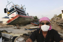 Tsunami. A volenteer takes a break from the clean up of the damage caused by the tsunami  nothing is left standing in the village  where 2500 people are pressumed dead  125kms north of Phuket on the 2...