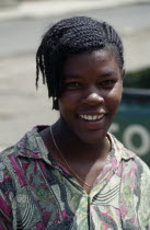 Head and shoulders portrait of smiling young woman.African Caribbean Female Women Girl Lady Grenadian Greneda Happy Immature One individual Solo Lone Solitary West Indies