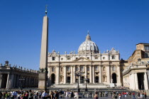 Vatican City The facade of the Basilica of Saint Peter with the obelisk in the foreground and tourists in Piazza San PietroEuropean Italia Italian Roma Southern Europe Catholic Principality Citta del...