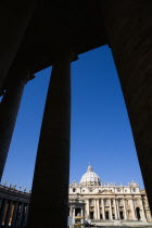 Vatican City The Basilica of St Peter seen through the pillars of the Ccolonnade by BerniniEuropean Italia Italian Roma Southern Europe Catholic Principality Citta del Vaticano History Papal Religion...