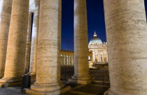 Vatican City The Basilica of St Peter seen through the pillars of the Ccolonnade by Bernini illuminated at nightEuropean Italia Italian Roma Southern Europe Catholic Principality Citta del Vaticano N...