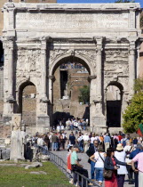 Tourists walking through the triumphal Arch of Septimius Severus from the Forum towards the CapitolEuropean Italia Italian Roma Southern Europe Gray History Holidaymakers Tourism Grey