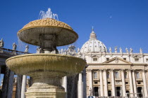 Vatican City The facade of the Basilica of St Peter with a water fountain and the colonnade by Bernini in the foregroundEuropean Italia Italian Roma Southern Europe Catholic Principality Citta del Va...