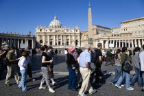 Vatican City Tourists in St Peters Square in front of the BasilicaEuropean Italia Italian Roma Southern Europe Catholic Principality Citta del Vaticano Holidaymakers Papal Religion Religious Tourism...