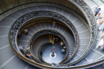 Vatican City Museum The Spiral Ramp by Giuseppe Momo dated 1932 with visitors walking downEuropean Italia Italian Roma Southern Europe Catholic Principality Citta del Vaticano Gray Holidaymakers Lear...