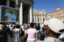 Vatican City Pilgrims in St Peters Square for the wednesday Papal Audience in front of the Basilica watching Pope Benedict XVI Joseph Alois Radzinger on a large video TV monitor displayEuropean Itali...