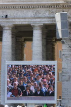 Vatican City Pilgrims seen on a large video TV monitor display in St Peters Square for the wednesday Papal Audience in front of the Basilica given by Pope Benedict XVI Joseph Alois RadzingerEuropean...