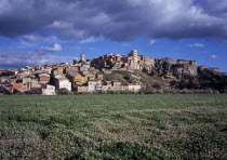 El Pinell de Brai. Hilltop village seen from field of flowers below European Scenic Southern Europe Espainia Espana Espanha Espanya Hispanic Spanish Catalunya Catalonia