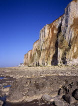 View north east from rocky foreshore at sea level towards chalk cliffs of the channel coast near and above the town of  Mers les Bains. PicardyEuropean Scenic French Western Europe Northern