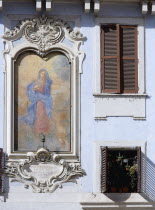 Religious fresco on the wall of a building in the Piazza Della Rotonda beside windows with shuttersEuropean Italia Italian Roma Southern Europe Religion