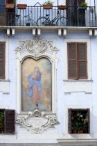 Religious fresco on the wall of a building in the Piazza Della Rotonda beside windows with shutters and bicycles on a balcony aboveEuropean Italia Italian Roma Southern Europe Religion