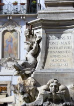 Detail of a dolphin on the Fountain of Piazza Della Rotonda by Giacomo Della Porta in 1575 with a religious fresco on the wall of a building beyondEuropean Italia Italian Roma Southern Europe Gray Hi...