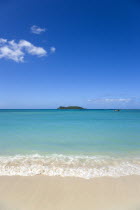 Gentle waves breaking on the shoreline of Paradise Beach in L Esterre Bay with Sandy Island sand bar on the horizonBeaches Resort Sand Sandy Scenic Seaside Shore Tourism West Indies Caribbean Grenadi...