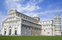 The Campo dei Miracoli or Field of Miracles.The Duomo Cathedral with tourists and the Leaning Tower or Torre Pendente belltower beyond under a blue skyEuropean Italia Italian Southern Europe Toscana...