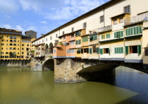 The 14th Century Ponte Vecchio or Old Bridge across the River Arno showing the backs of the goldsmiths workshops that hang over the waterEuropean Italia Italian Southern Europe Toscana Tuscan Firenze...