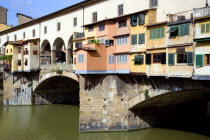 The 14th Century Ponte Vecchio or Old Bridge across the River Arno showing the backs of the goldsmiths workshops that hang over the waterEuropean Italia Italian Southern Europe Toscana Tuscan Firenze...