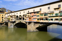 The 14th Century Ponte Vecchio or Old Bridge across the River Arno showing the backs of the goldsmiths workshops that hang over the waterEuropean Italia Italian Southern Europe Toscana Tuscan Firenze...