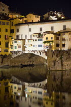 The 14th century Ponte Vecchio or Old Bridge across the River Arno illuminated at nightEuropean Italia Italian Southern Europe Toscana Tuscan Firenze History Nite