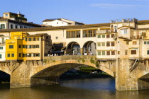 The 14th century Ponte Vecchio or Old Bridge across the River Arno at sunset with tourists on the bridgeEuropean Italia Italian Southern Europe Toscana Tuscan Firenze History Holidaymakers Tourism