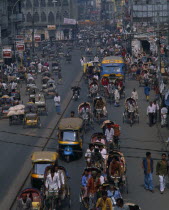 Street scene from above with trishaws  peopleand bus shops Asia Asian Bangladeshi Dacca Asia Asian Bangladeshi Dacca