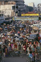 Street crowded with brightly painted and decorated rickshaws.Dacca Asia Asian Bangladeshi Dacca Asia Asian Bangladeshi