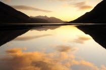 Sunset coloured clouds reflected in Loch Etivewide angle landscape Alba Colored Great Britain Northern Europe Scenic UK United Kingdom White British Isles European Sundown Atmospheric wide angle lan...