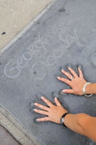 Fitting into George Clooneys hands  Manns Chinese Theatre  Hollywood. GraumansAmerican Asian Destination Destinations North America Northern Theater United States of America Gray LA One individual So...