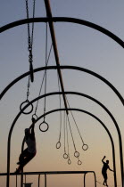 Silhouetted Gymnasts on the rings  Santa Monica beachSanta Monica American Beaches Destination Destinations North America Northern Resort Sand Sandy Seaside Shore Tourism United States of America LA...