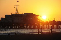 Santa Monica pier Silhouetted at sunsetSanta Monica American Destination Destinations North America Northern United States of America LA Solid Outline Shade Silhouette Sundown Atmospheric The Golden...