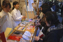 ingumae - Meijijingu shrine  New Years worshippers buying omamori good luck charms for the New yearAsia Asian Japanese Nihon Nippon Religion Religious