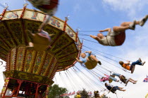 Findon village Sheep Fair Children in motion riding on a swing carousel.Great Britain Northern Europe UK United Kingdom British Isles European