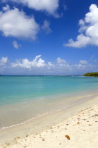 Waves breaking on Paradise Beach at LEsterre Bay with the turqoise sea and Sandy Island sand bar beyond.Beaches Resort Sand Sandy Scenic Seaside Shore Tourism West Indies Caribbean Destination Destin...