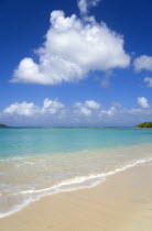 Waves breaking on Paradise Beach at LEsterre Bay with the turqoise sea and Sandy Island sand bar beyond.Beaches Resort Sand Sandy Scenic Seaside Shore Tourism West Indies Caribbean Destination Destin...