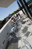 Towner Gallery building balcony outside the cafe area with visitors drinking coffee.European Great Britain Northern Europe UK United Kingdom British Isles Bar Bistro Holidaymakers Restaurant Tourism...