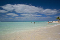 Isla Mujeres exotic tropical beach with blue-sky and white clouds and three people ready to swim at the crystal clear seawater.Tropical beachIdealSeaSunSummerHolidaysVacationParadiseDream des...