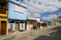 Isla Mujeres  Calle Guerrero. Traditional colored Mexican houses shoot on a bright day with blue sky and white clouds.PremisesArchitectureCultureTraditionLifestyleStructureHomeHaciendaHoliday...