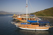 Pleasure boats moored off Gemiler Island with Byzantine ruins behind.  Also known as St Nicholas Island.Fethiyeformerly Telmessosformerly modern Greek MakriAegeanTurkish rivieraGemilersaint Nic...