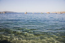 Expanse of clear water with line of Gulet boats at anchor.Turkish Aegean coastmediterraneanresortformerly HalicarnassusHalikarnasregion of CariaDorian Greek occupiedsunlightsunshinesummerse...