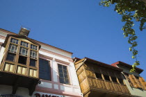 Part view of painted facades of Ottoman era wooden houses against blue sky. Fethiyeformerly Telmessosformerly modern Greek MakriAegeanTurkish rivieraLycianLyciaOttomansummerseasonsunholida...