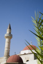 Defterdar Mosque on Plateia Eleftherias Square at centre of Kos Town.  Minaret of Ottoman style as the island was once Ottoman territory.Greek Islands Resort Summer Clear Blue Sky early season Aegean...