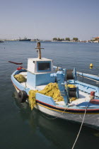 Pale blue and white painted traditional fishing boat moored in the harbour.Greek IslandsResort Summer Clear Blue Sky early season Aegean DodecaneseDestination Destinations Ellada European Greek Sout...