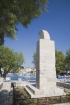 Stone monument in the harbour.sculptureResort Summer Clear Blue Sky early season Aegean Dodecanese Destination Destinations Ellada European Greek Southern Europe